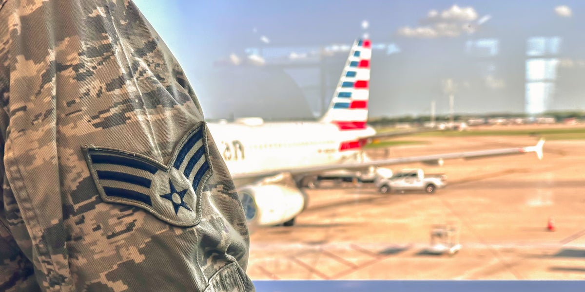 Military woman in airport with AA plane tail