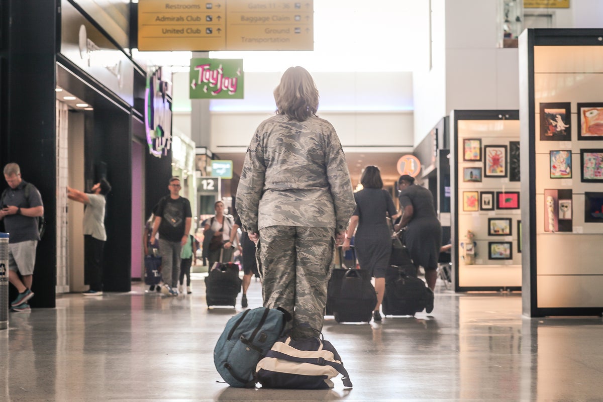 Military woman standing in airport