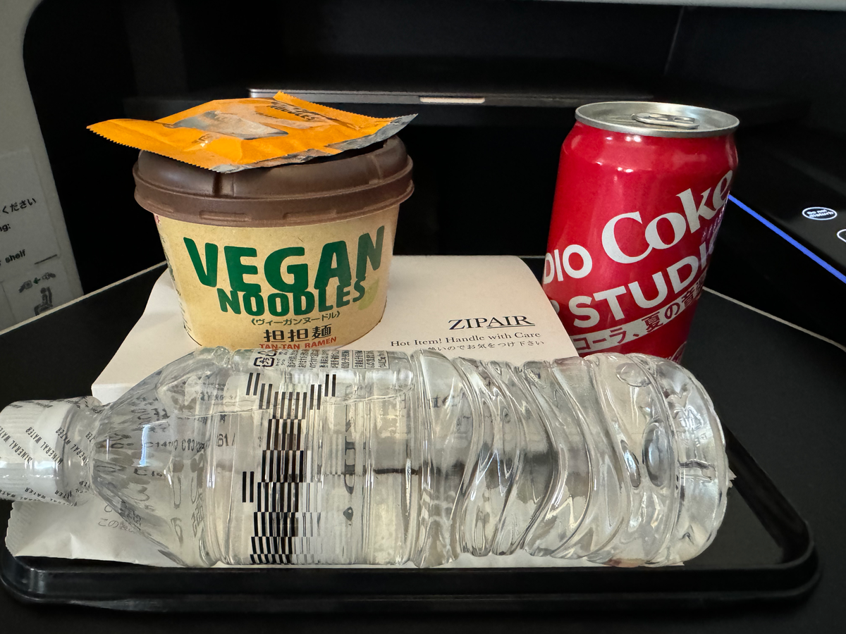 Zipair LAX NRT noodles coke water on tray