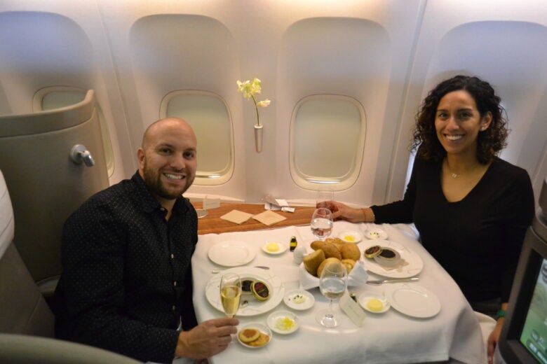 Enjoying a romantic dinner with my wife Stephanie aboard Cathay Pacific's first class on the Boeing 777-300, soaring 38,000 feet in the air.