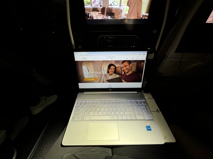 Etihad B787 9 Economy KIX AUH laptop on tray table Etihad B787 9 Economy KIX AUH laptop on tray table