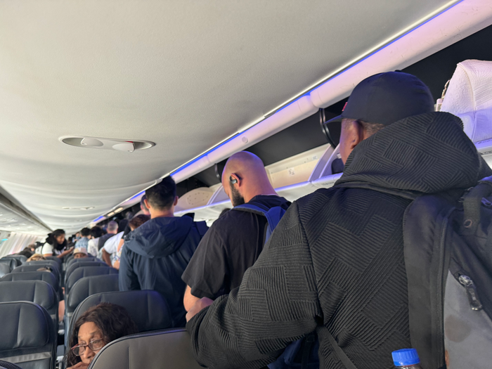 Alaska Airlines B737 9 MAX LAX BZE passengers in aisle Alaska Airlines B737 9 MAX LAX BZE passengers in aisle