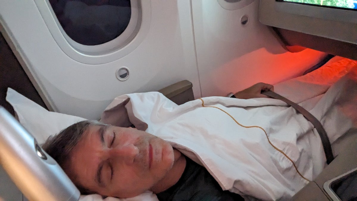 Alberto sleeping in business class on Shanghai Airlines