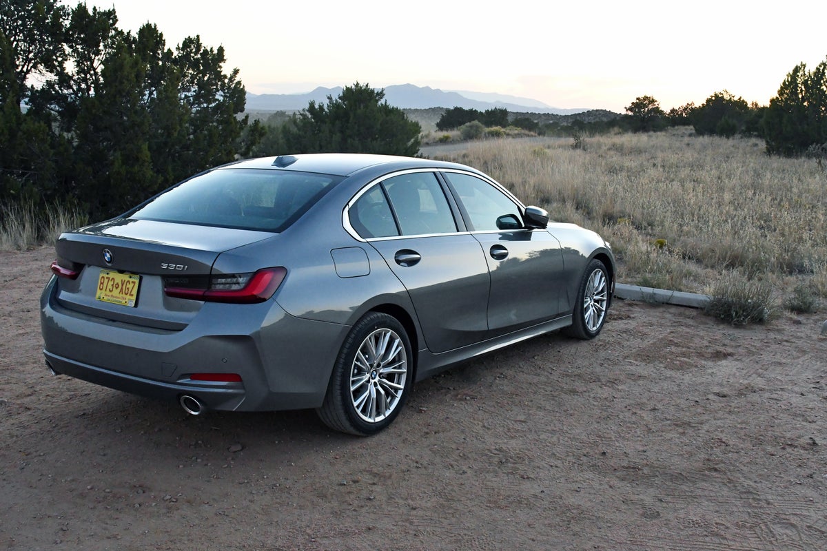 A 2024 BMW 330i rental car from Sixt parked in the high desert outside Santa Fe, New Mexico