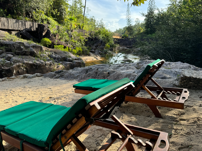 Blancaneaux Lodge Belize Mr Mrs Smith lounge chairs next to river Blancaneaux Lodge Belize Mr Mrs Smith lounge chairs next to river