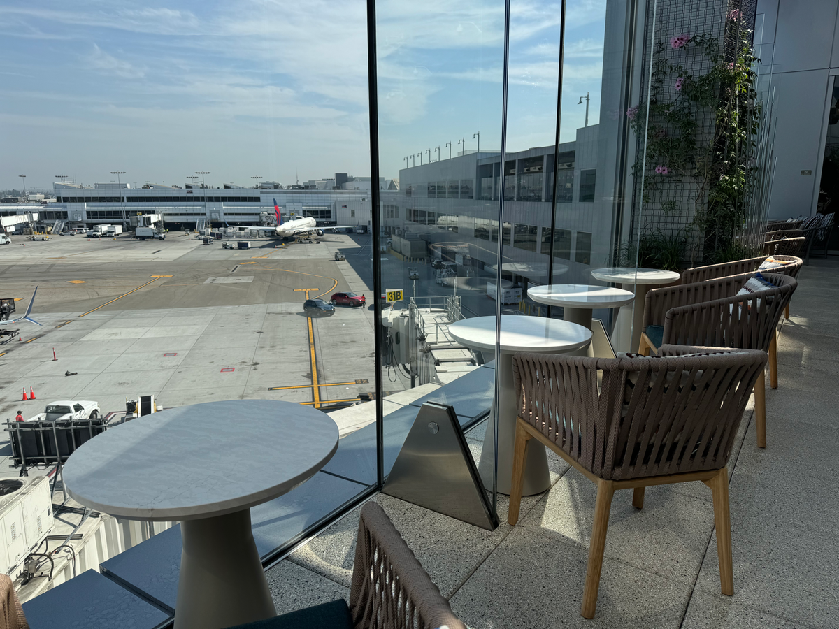 Delta One Lounge LAX terrace seating at glass panel