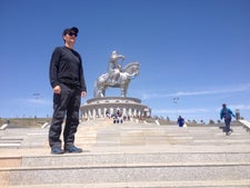 Ryan Smith in Mongolia in front of Genghis Khan statue