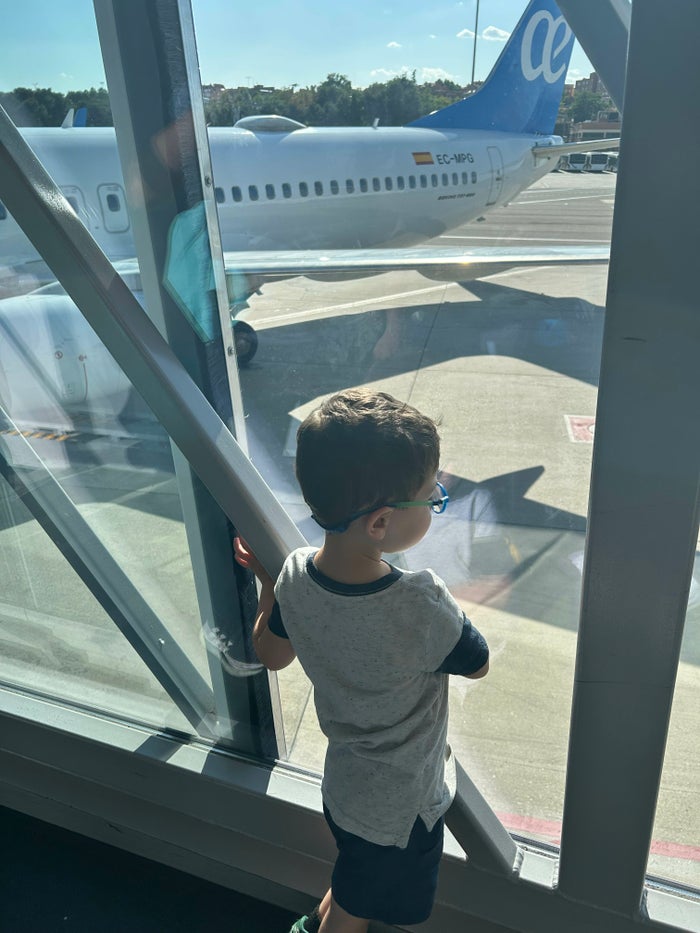 Kid looking at plane Toddler airport