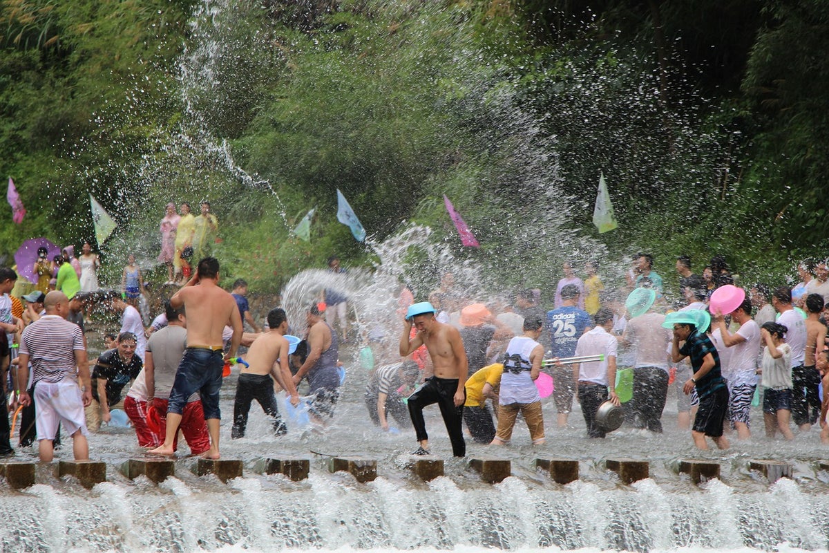 People spraying water at each other