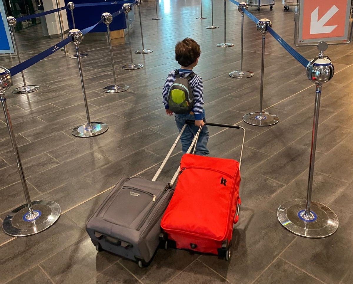 Kid with suitcases in airport