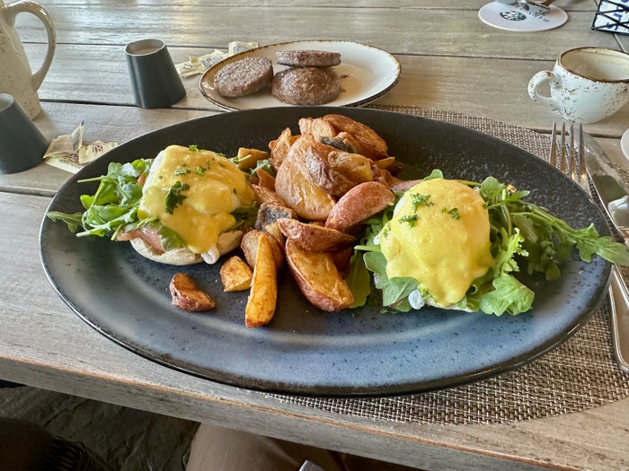 A plate with eggs benedict on a table A plate with eggs benedict on a table