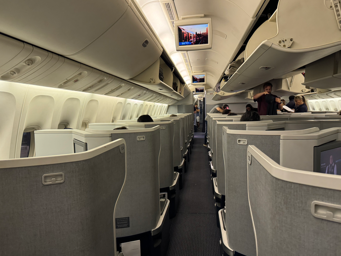 American Airlines B777 30 Business class seats front aisle view American Airlines B777 30 Business class view up the aisle