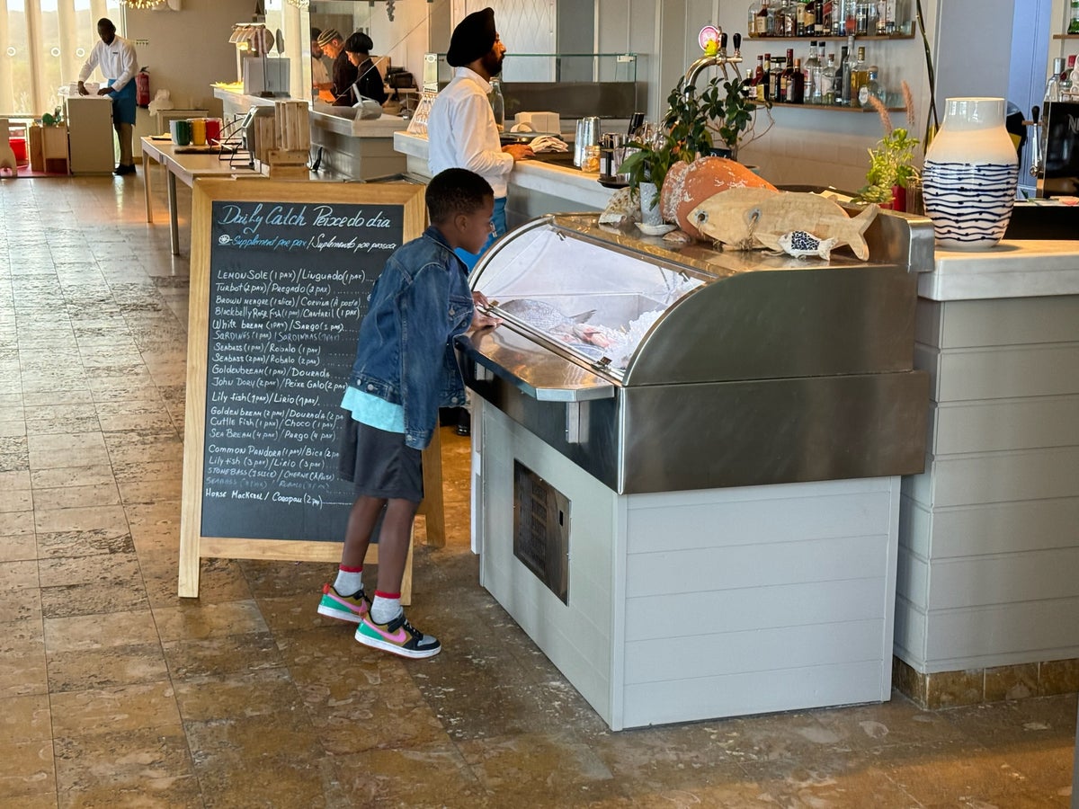 Ashley Onadeles son looking at fresh fish Martinhal Sagres Beach Family Resort