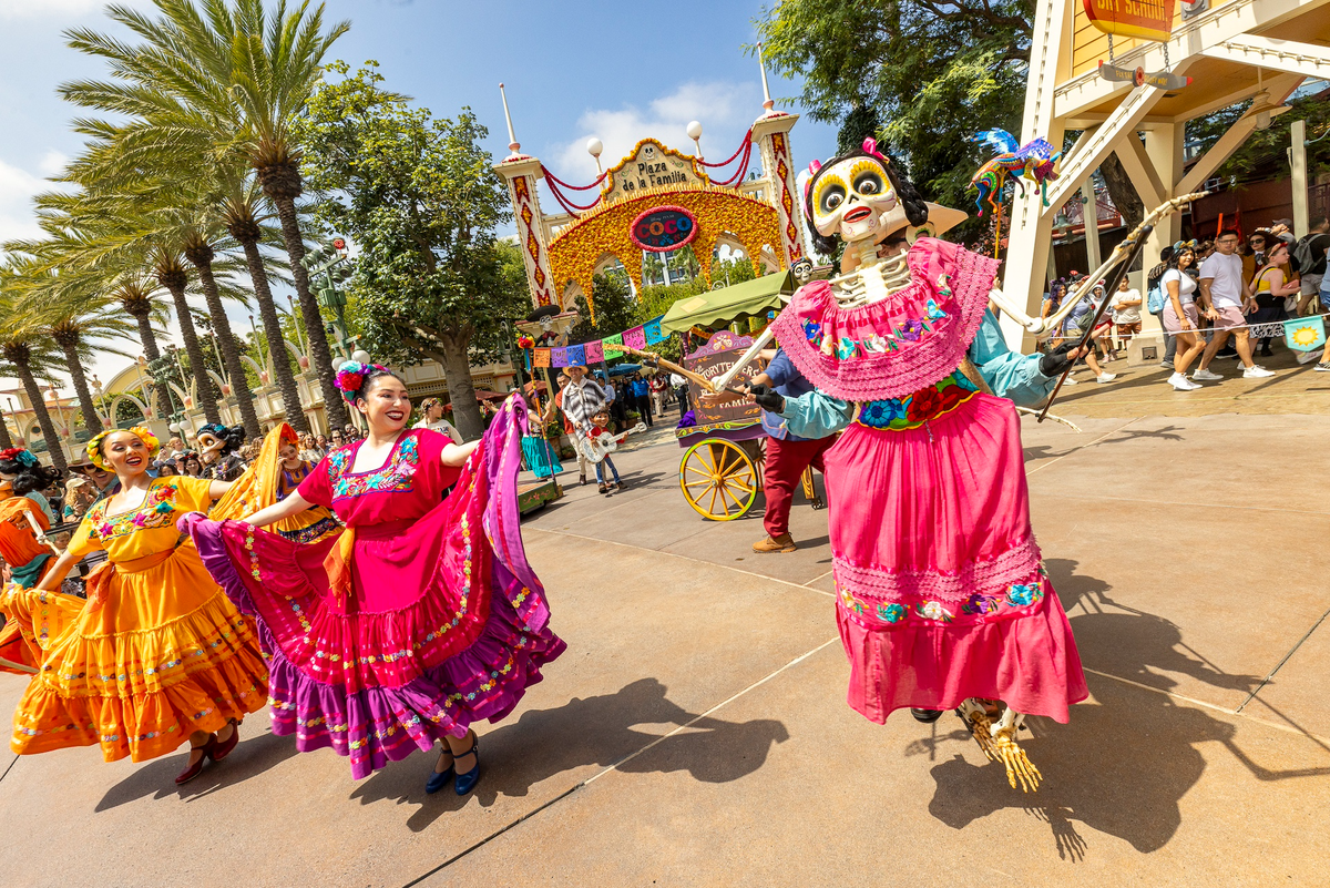 dancers and Coco-themed attractions in a parade