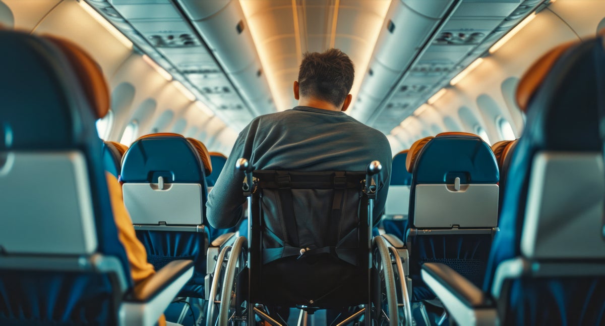 Man in wheelchair on airplane for accessible travel