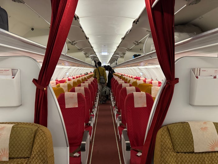 Air India A320 Economy DOH BOM entry from business