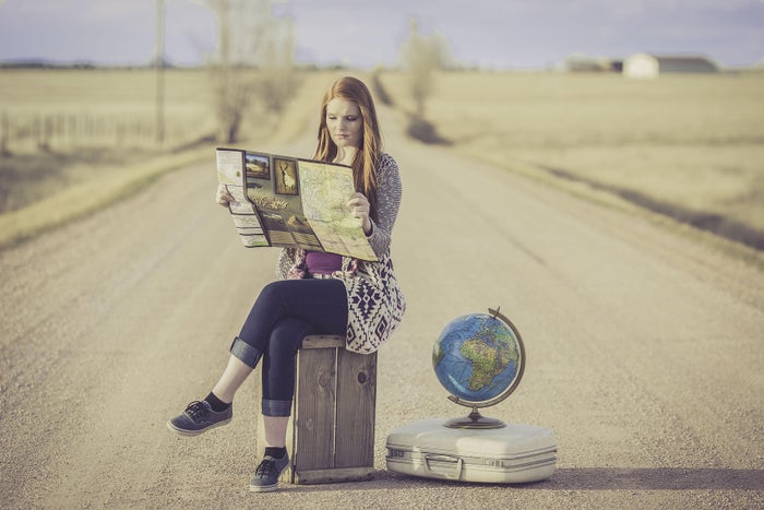 Girl with map in road