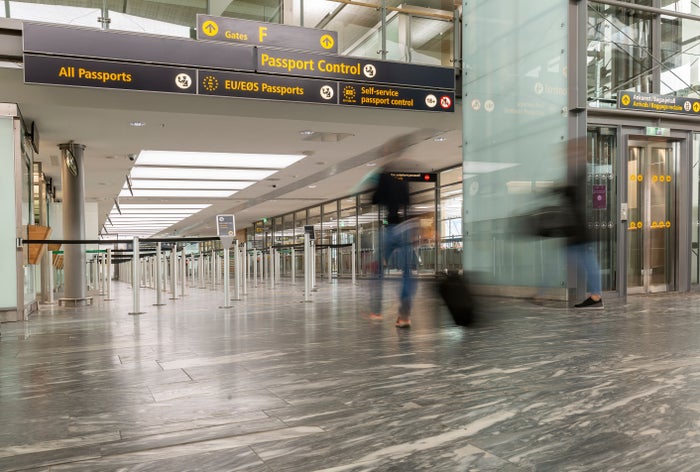 Passengers following EU passport control signs closeup Passengers following EU passport control signs closeup