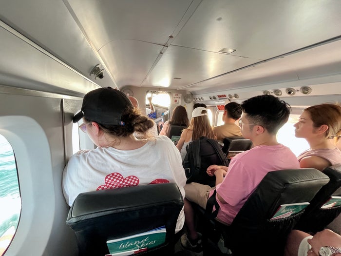 Alaska Air crew with masks Interior of a seaplane filled with passengers