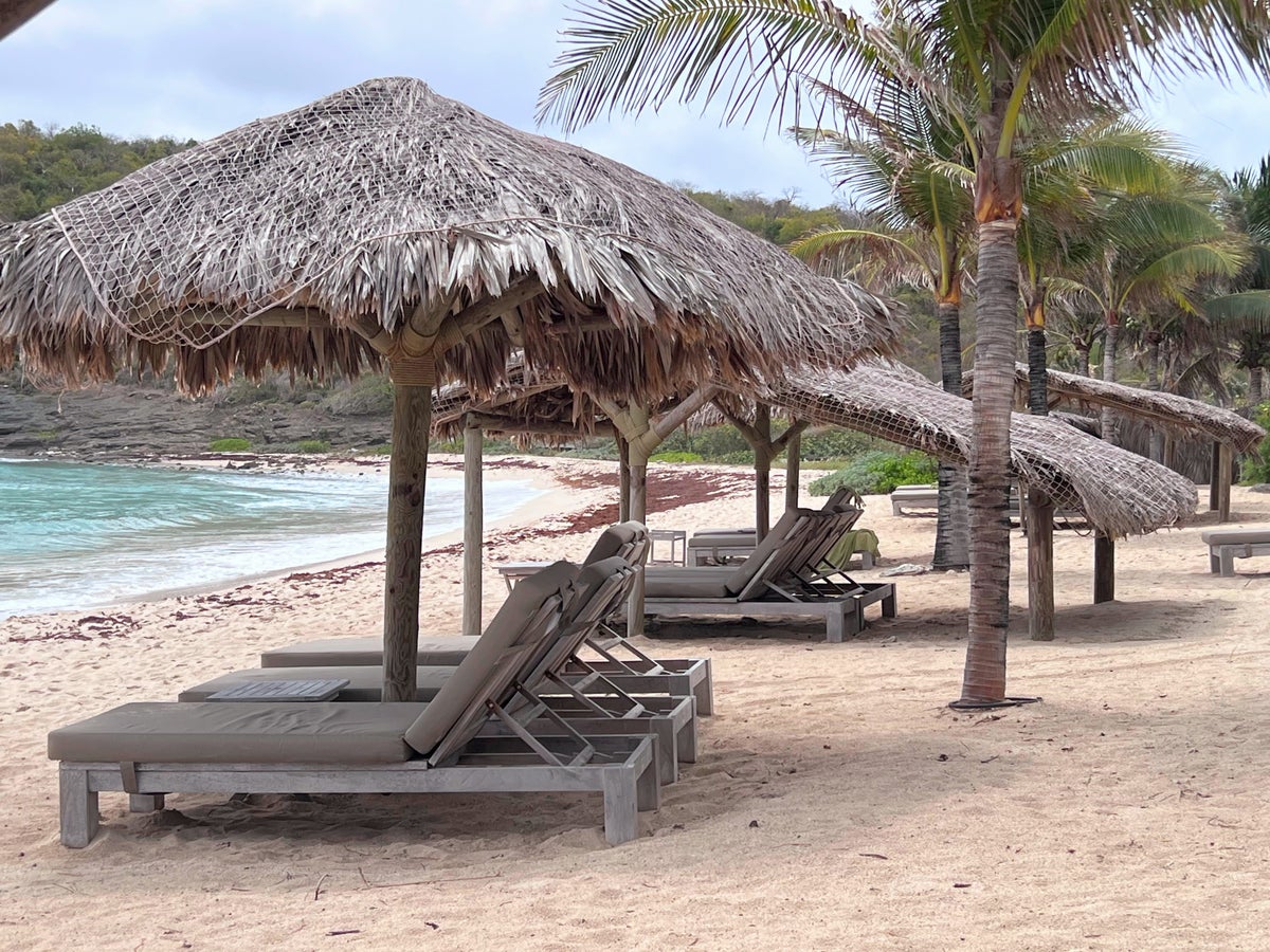 2 Shaded loungers on beach at Hotel Manapany