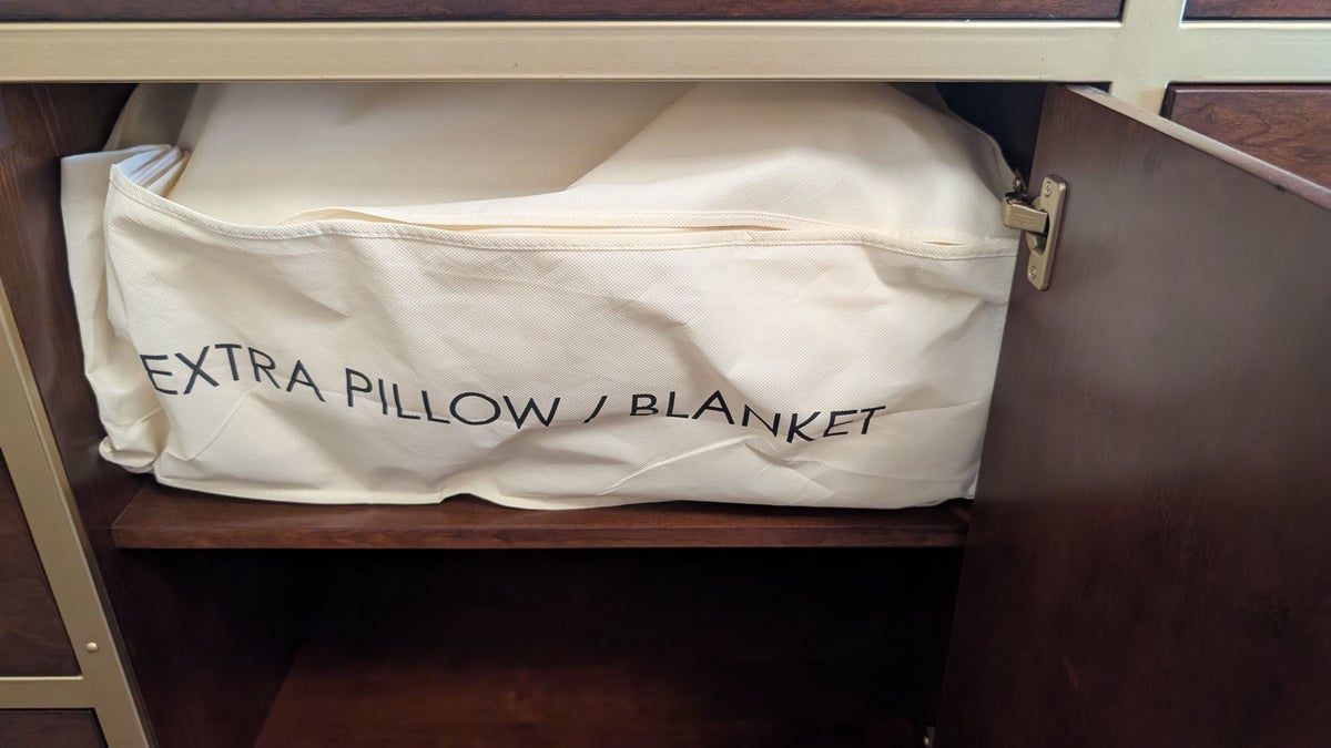 Disneys Yacht Club Resort guest room dresser extra pillow and blanket