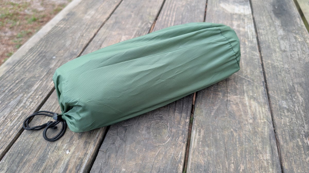 Self inflating sleeping pad rolled up in its storage bag