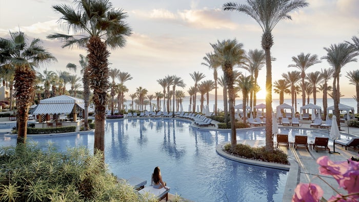 Four Seasons Sharm El Sheikh pool Pool, palm trees, and sunset over the sea