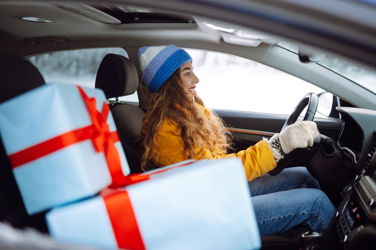 Woman driving in winter with gifts in car