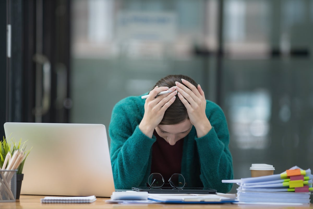 Frustrated woman at laptop