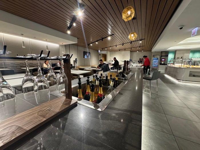 AA Flagship Lounge champagne and wine Champagne and wine bottles in an airport lounge