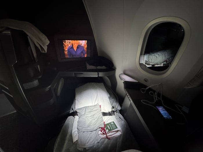 AA Flagship Suite Business Class lie flay bed above angle AA Flagship Suite Business Class lie flay bed above angle