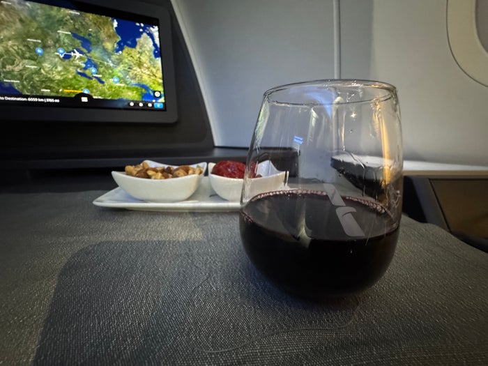 AA Flagship Suite Business Class peanuts, olivies, red wine AA Flagship Suite Business Class peanuts, olivies, red wine