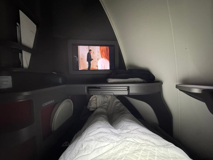 AA Flagship Suite Business Class watching TV from lie flat position AA Flagship Suite Business Class watching TV from lie flat position