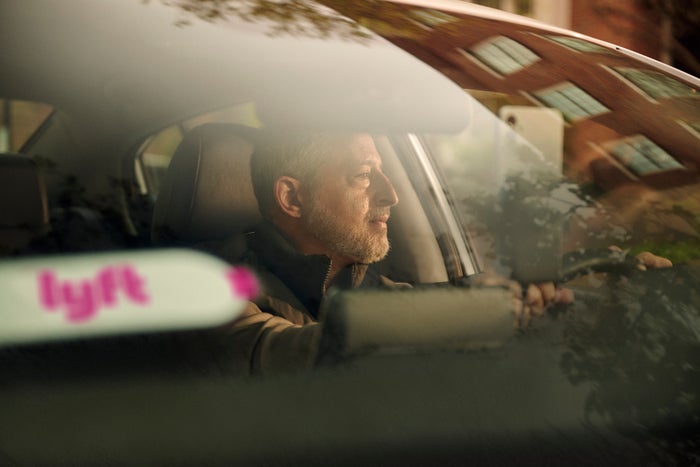 Man driving a Lyft vehicle Man driving a Lyft vehicle