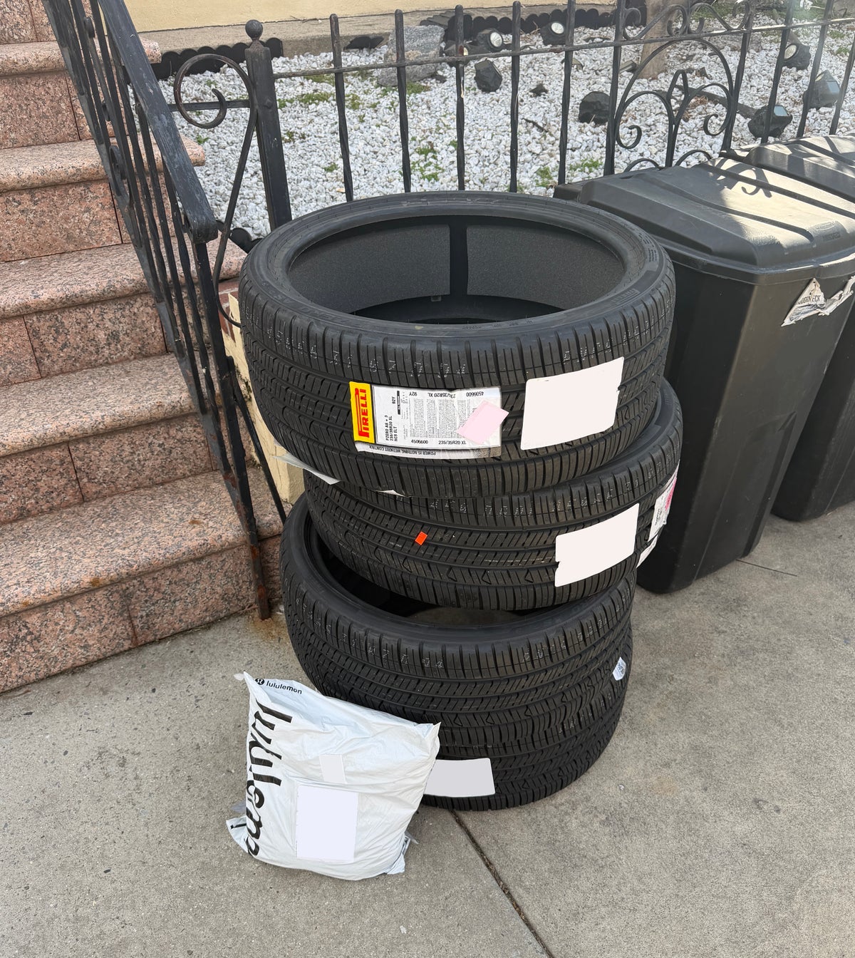Stack of car tires in front of a house
