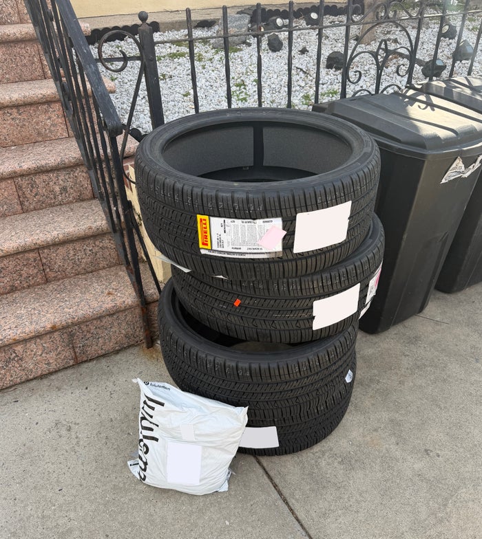 Stack of car tires in front of a house Stack of car tires in front of a house