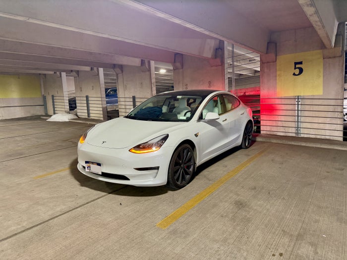 Tesla Model 3 in a parking garage Tesla Model 3 in a parking garage