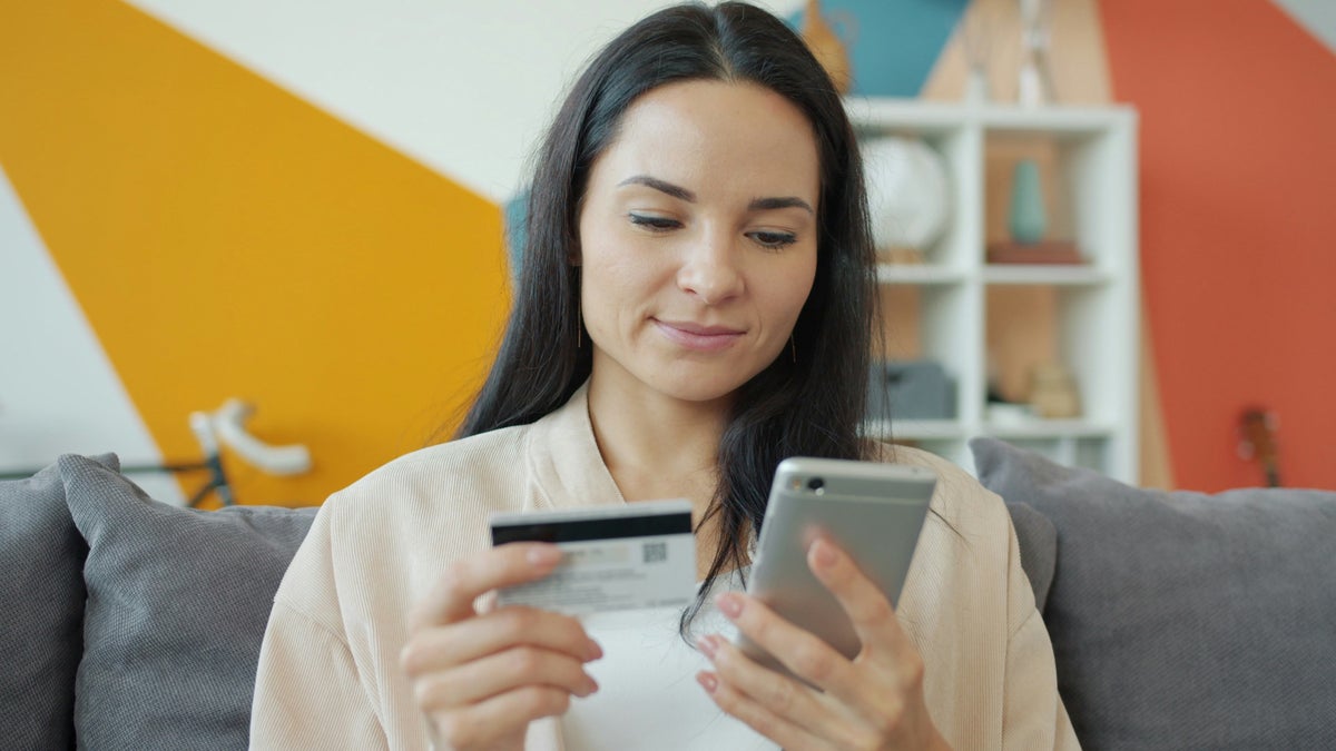 Woman holding credit card and smart phone