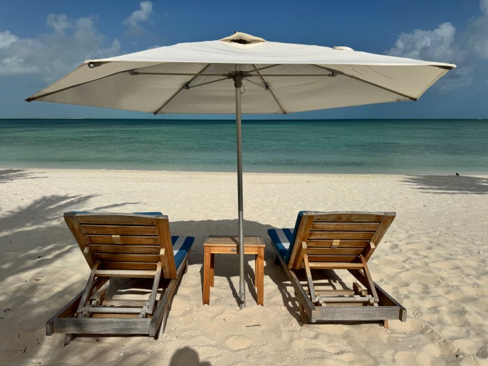 Ambergris Cay beach chairs and umbrella