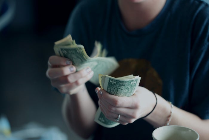Person Holding Dollar Bills Cash Back